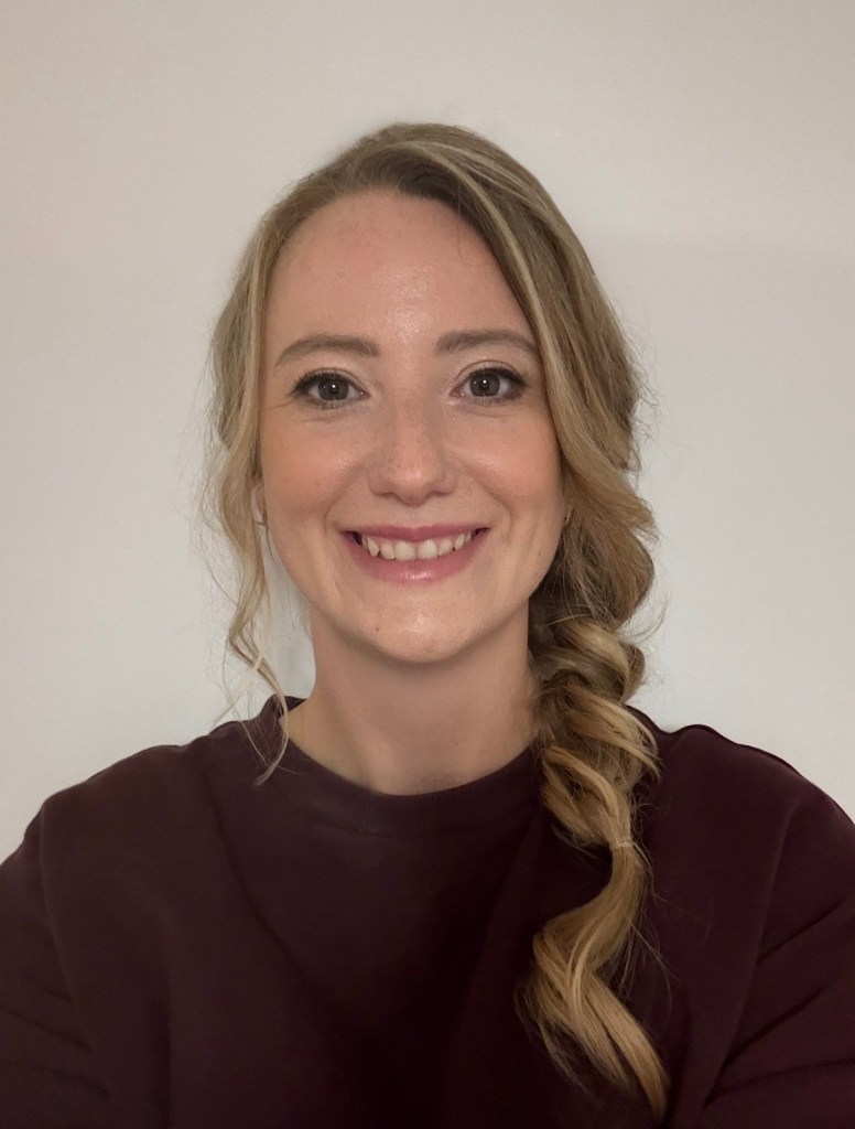 Portrait of Anouk Moser, EEG Co-Chair, smiling and wearing a dark top
